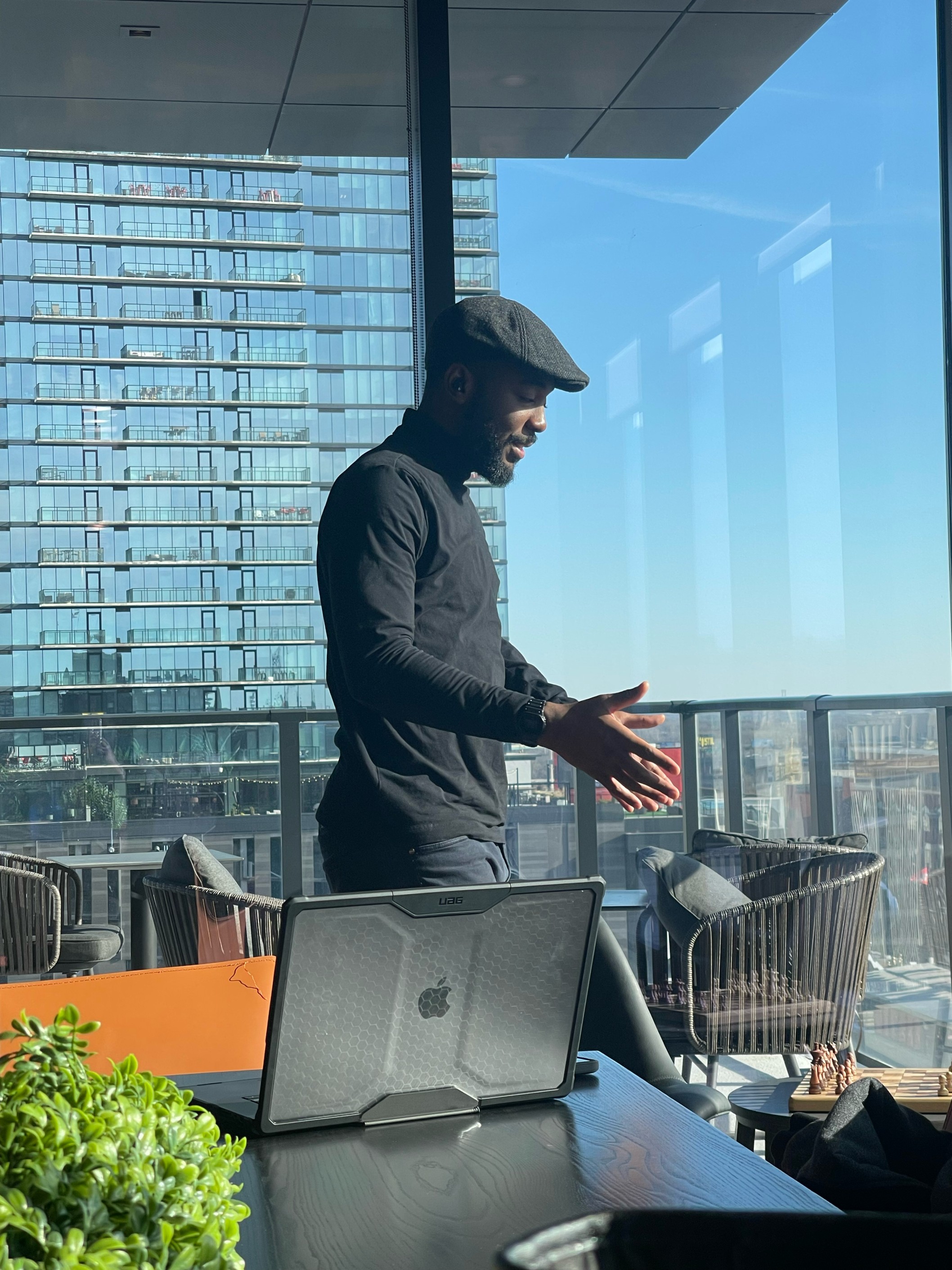 Theo Ossinga in profile overlooking a city balcony.